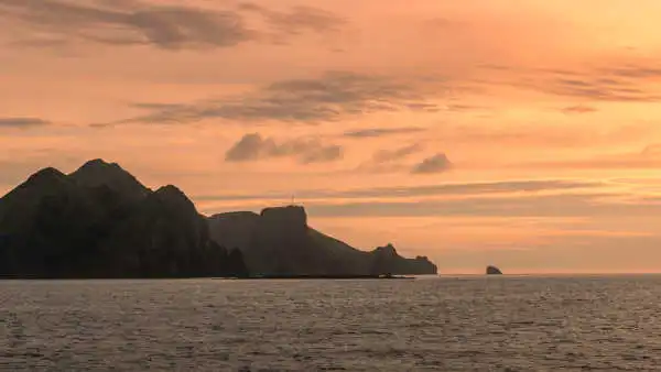 Sunset over a green island